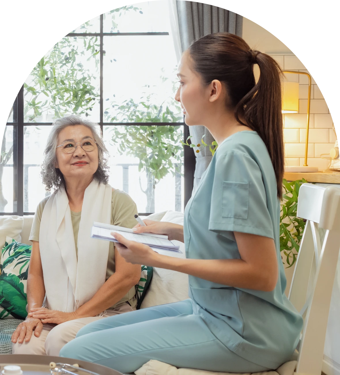 Caregiver discussing with older adult on couch